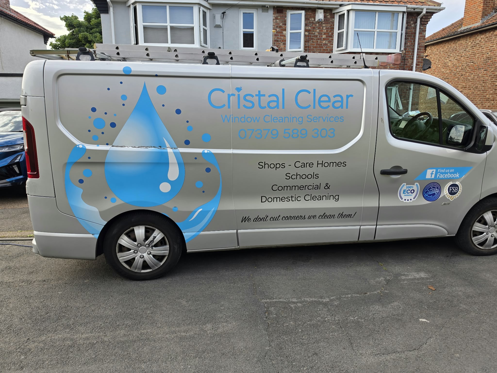 Silver Cristal Clear Window Cleaning Services van with a ladder on the roof, listing shops, care homes, schools and commercial and domestic cleaning